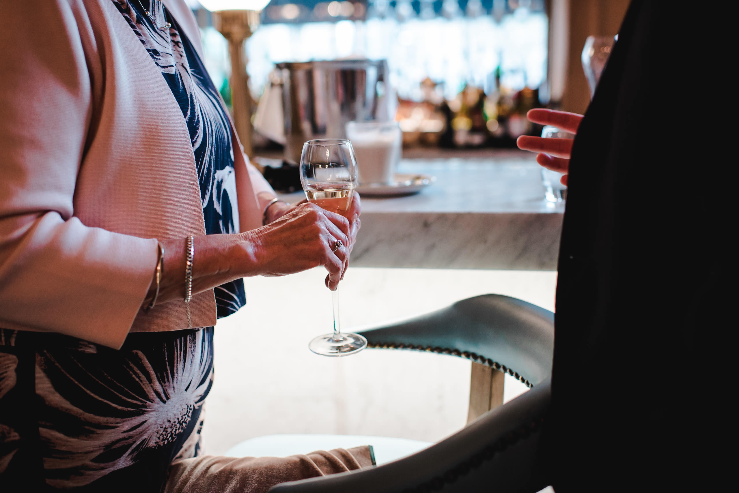 Woman holding champagne in Caffe Grande in Manchester