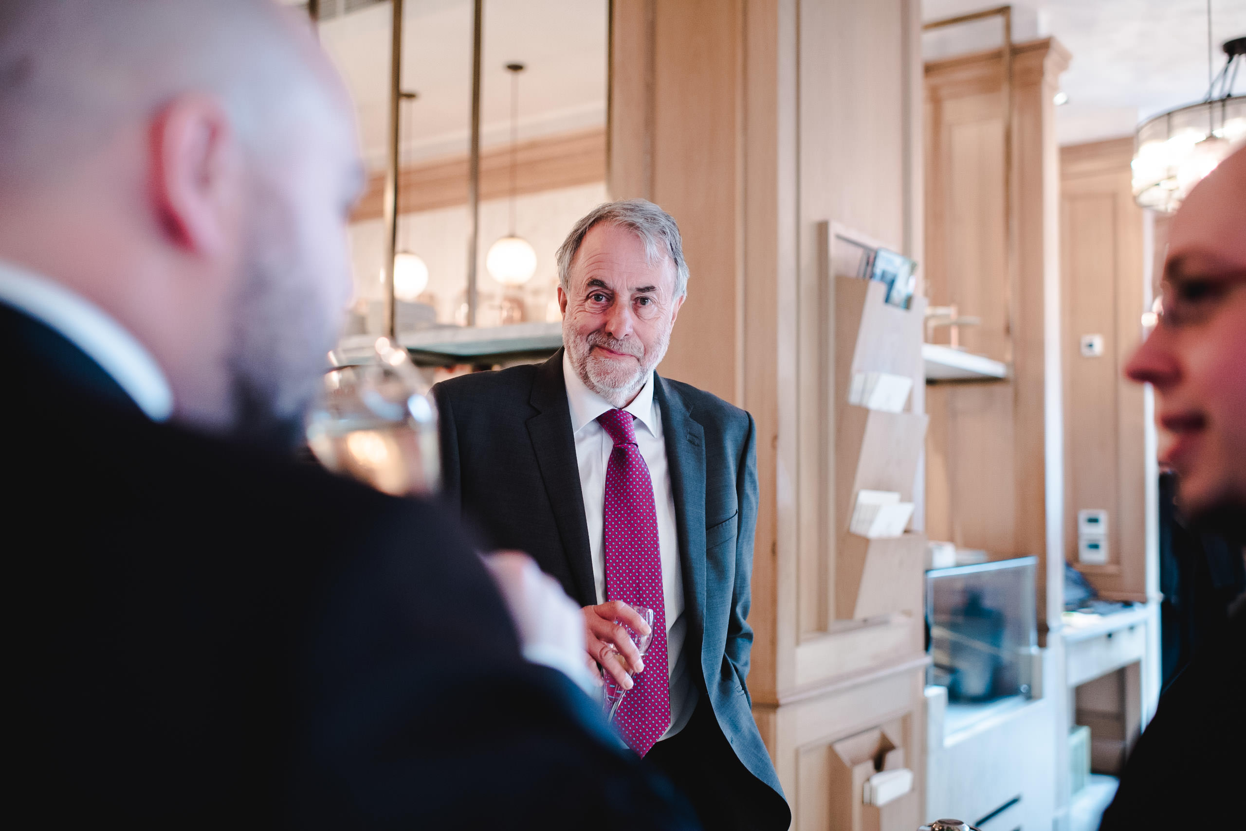 Gentleman holding glass of champagne at wedding in manchester