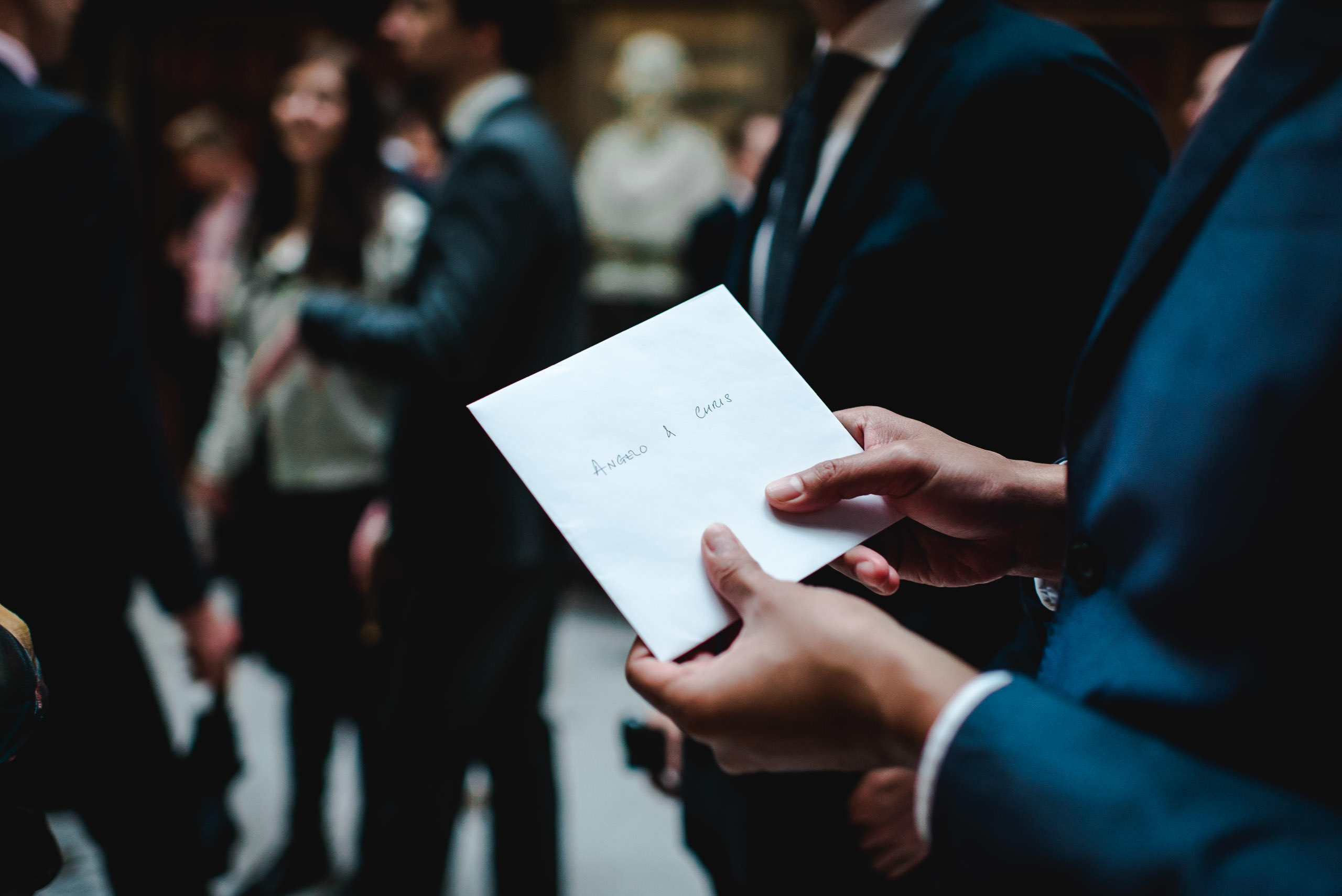 Wedding card in guests hands at Manchester Town Hall