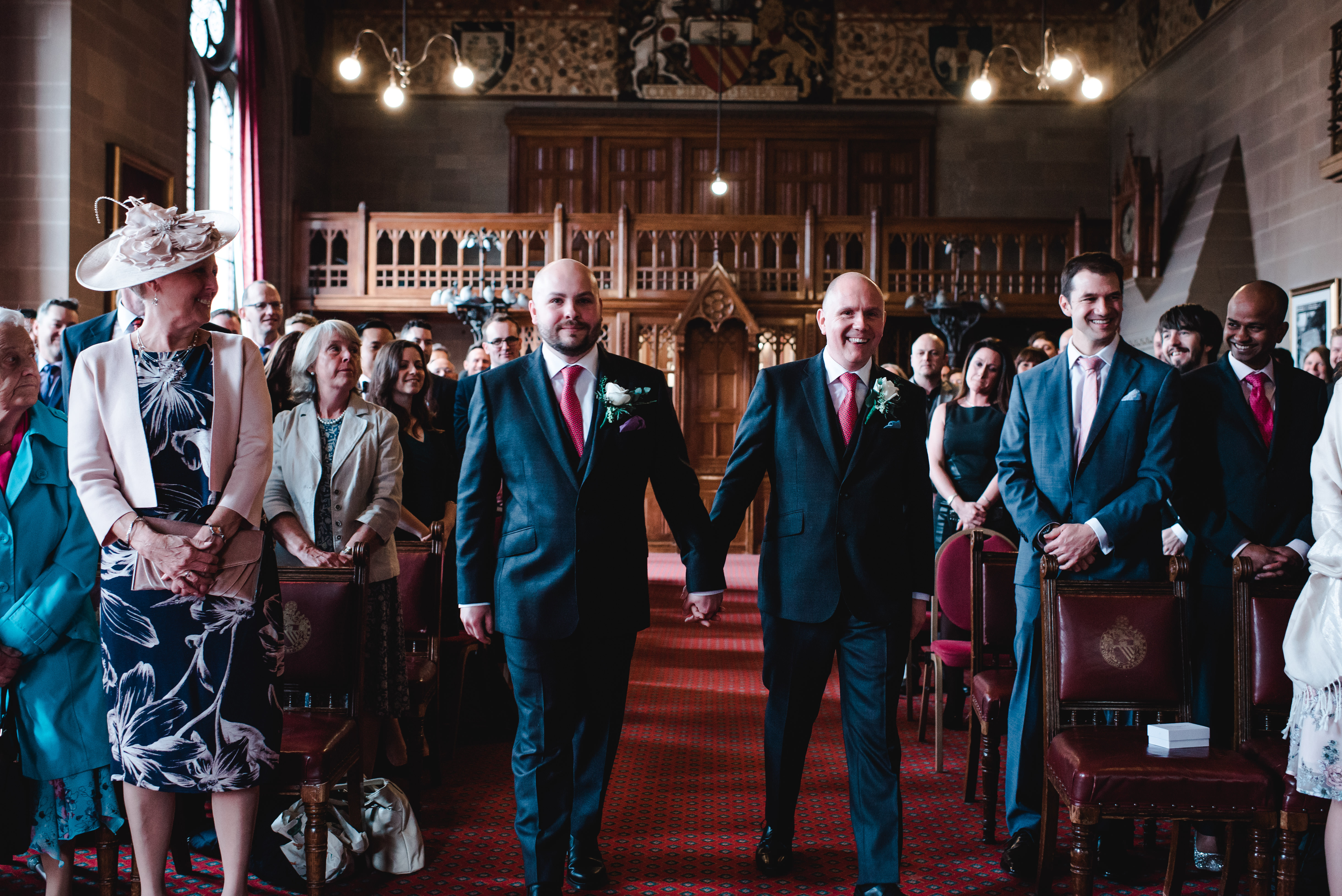 Groom and groom walking up the aisle at Manchester Town Hall
