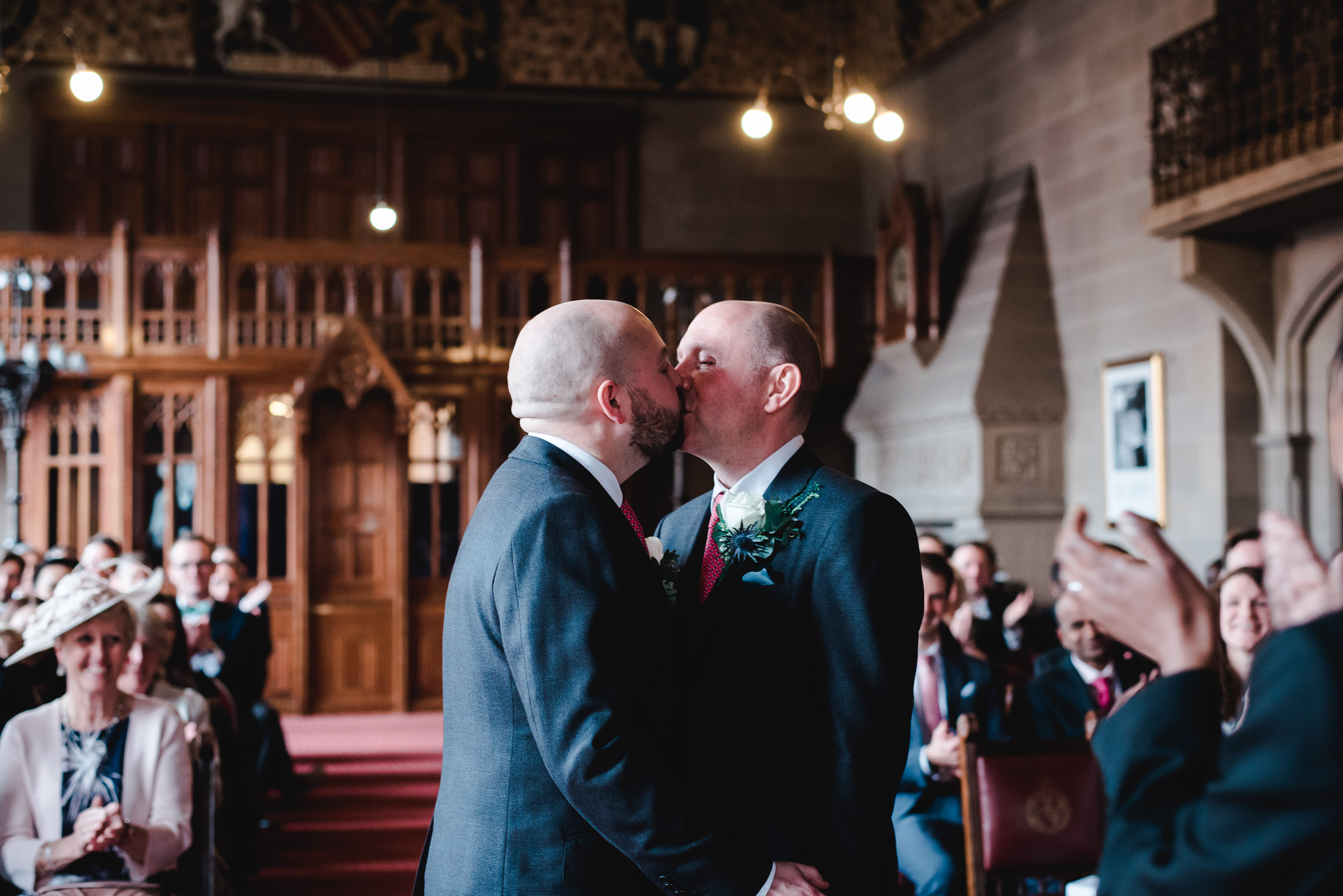 Groom and grooms first kiss at ceremony at Manchester Town Hall