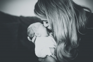 Mum kissing newborn at a Cheshire Lifestyle Family Photography Session
