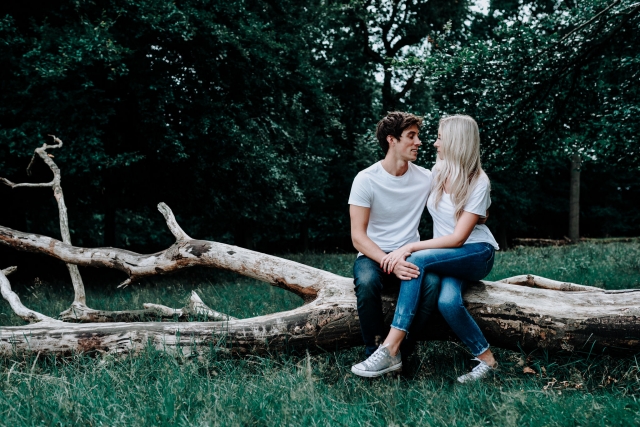 Lauren and Christopher sat on a log at Cheshire Engagement Session